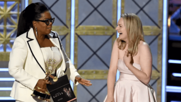 Elisabeth Moss accepts the Outstanding Drama Series prize The Handmaid’s Tale won from Oprah Winfrey. Photo by Kevin Winter/Getty Images